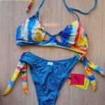 COSTUME DONNA 4GIVENESS DELLA STAGIONE ESTATE 2025. TOP NON IMBOTTITO E BRASILIANA A V CON FIOCCHI. FANTASIA PYTON COLORATA E DEMIN