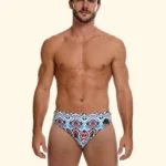 COSTUME UOMO EFFEK DELLA STAGIONE ESTATE 2026. SLIP A FANTASIA ETNICA TURCHESE E COCCIO CON BASE PANNA